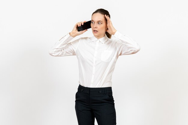 female worker in elegant white blouse talking on phone on light-white