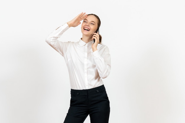 female worker in elegant white blouse talking on phone on white