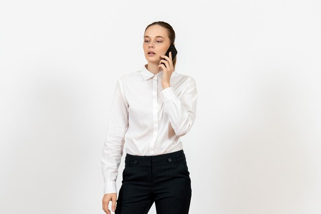 female worker in elegant white blouse talking on phone on white