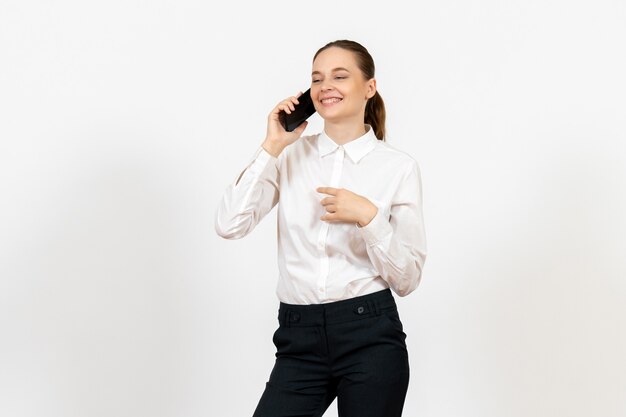 female worker in elegant white blouse talking on phone on white