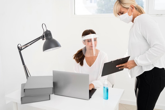 Female working together and wearing face protection