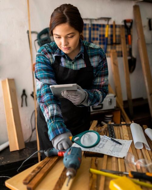 female working in workshop with magnifying glass