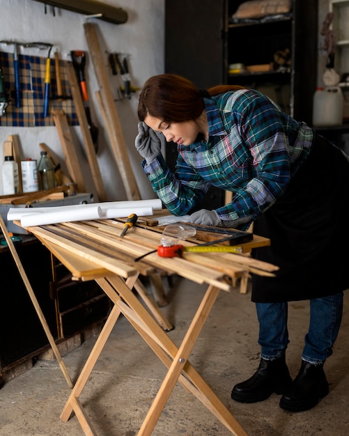 Female in workshop calculating