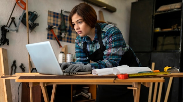 Female in workshop checking laptop