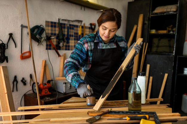 Female in workshop painting