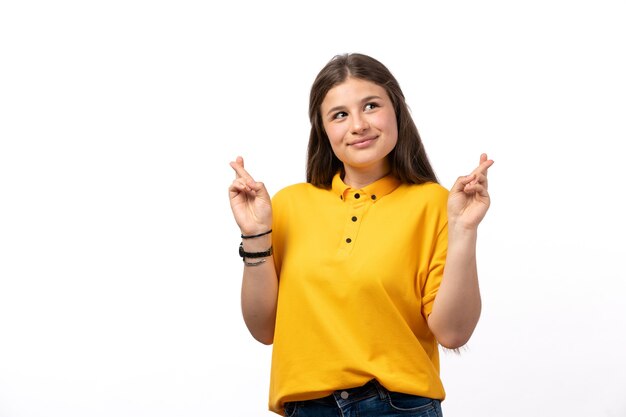 female in yellow shirt and blue jeans posing with happy expression on the white background woman model clothes