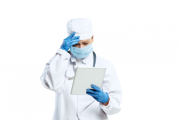 Female young doctor with stethoscope and face mask isolated on white