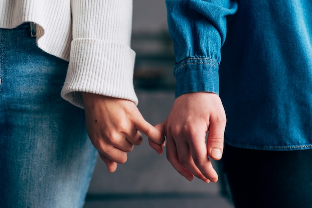 Females hooking each other little finger