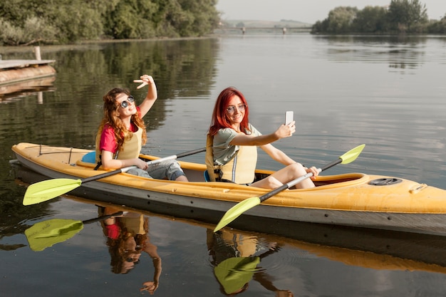 Females in kayak taking selfie
