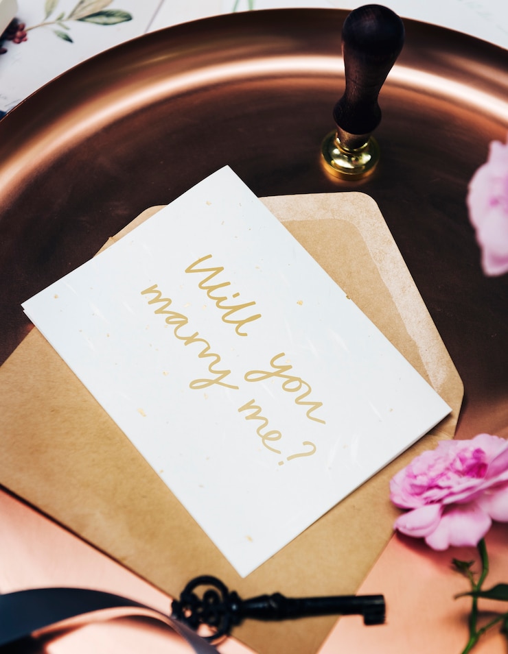 Free Photo feminine flat lay of a marriage proposal card
