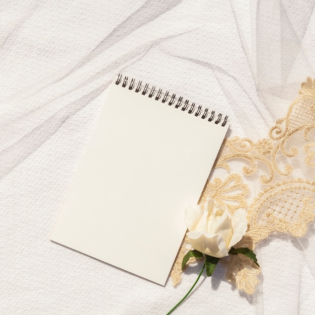 Feminine wedding arrangement with empty notepad close-up