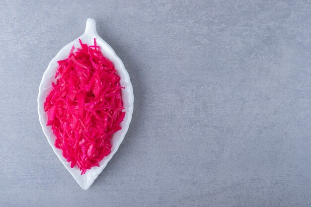 Fermented food. Sauerkraut in fancy dish , on the marble background.