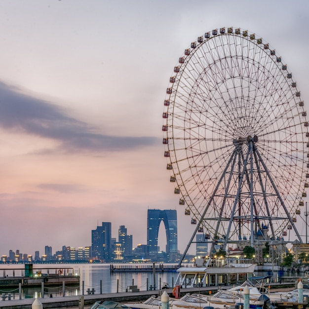 ferris wheel with cityscape in background