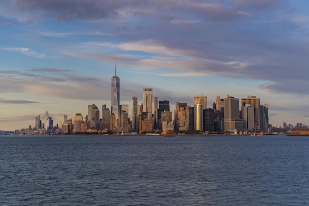 Ferry to Manhattan. View of Manhattan from the water at sunset, New York, USA