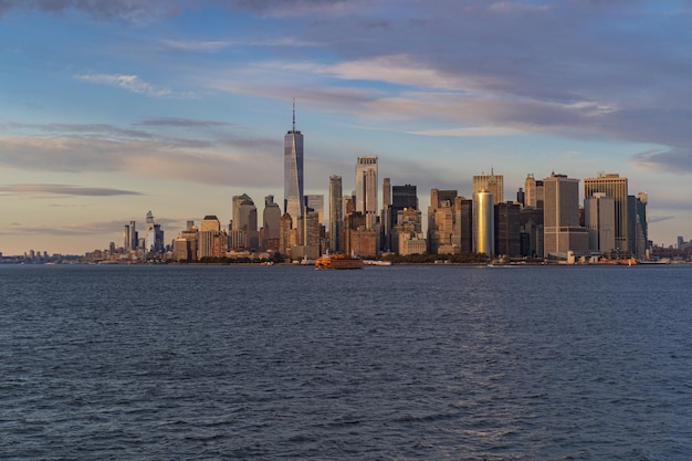 Ferry to Manhattan. View of Manhattan from the water at sunset, New York, USA