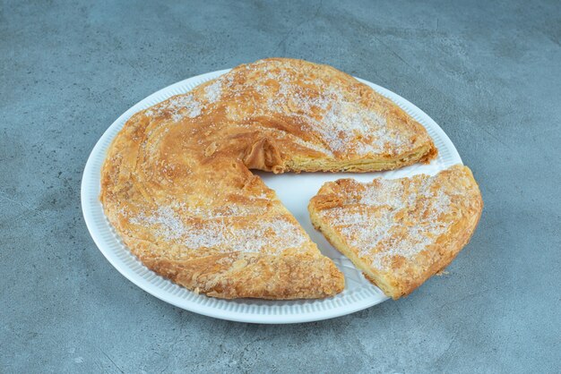 Feseli, azerbaijanian flaky flatbread on a platter, on marble.