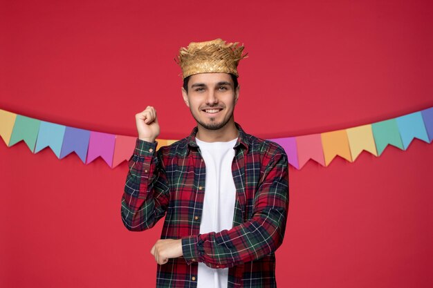 Festa junina in straw hat cute happy guy celebrating brazilian festival ready to dance