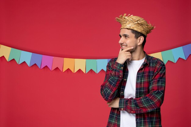 Festa junina wearing straw hat cute happy guy celebrating brazilian festival looking far