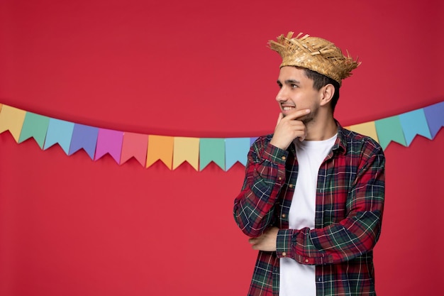 Festa junina wearing straw hat cute happy guy celebrating brazilian festival looking far