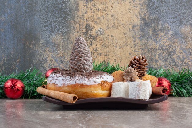 Festive arrangement of sweets on a platter on marble.