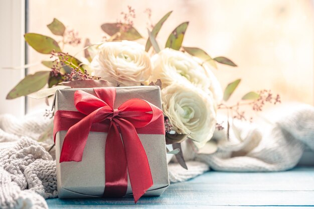 Festive background with gift box and flowers