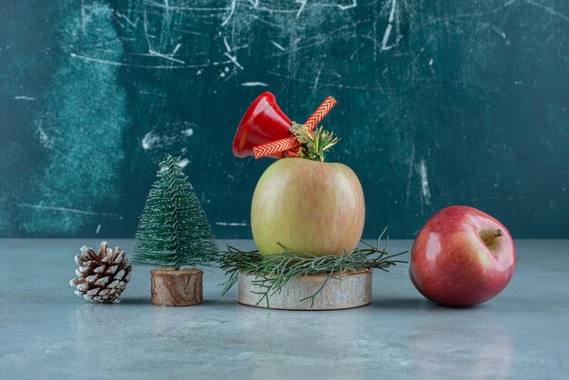 大理石のリンゴとクリスマスの飾りのお祝いの構成。