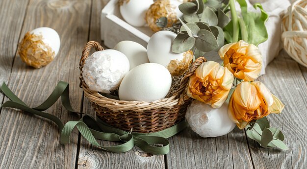 Festive composition for the Easter holiday with fresh spring flowers and eggs. Easter decor concept.