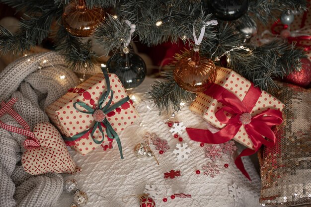 Festive gift boxes under the Christmas tree closeup