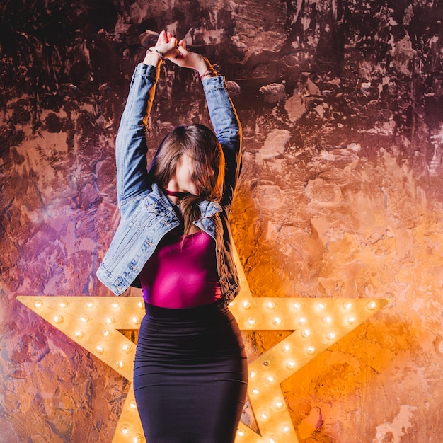 Festive girl posing in star light