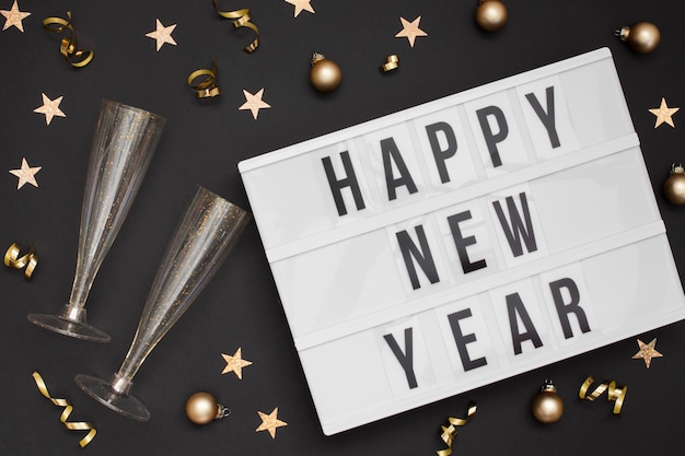 Free photo festive glasses with happy new year sign