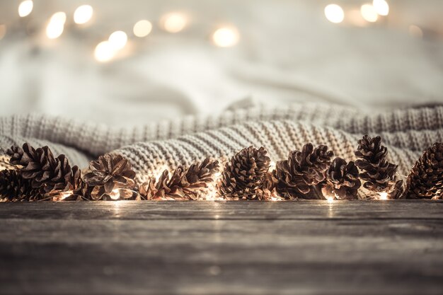 Festive New year background with cones and lights.