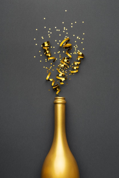 Festive new year composition with golden bottle