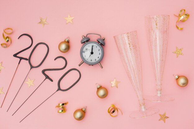 Festive party decoration with alarm clock and glasses