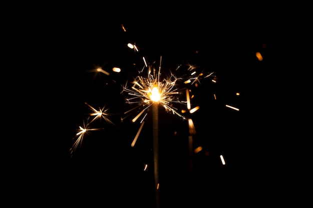 Free photo festive shiny sparkler in the dark