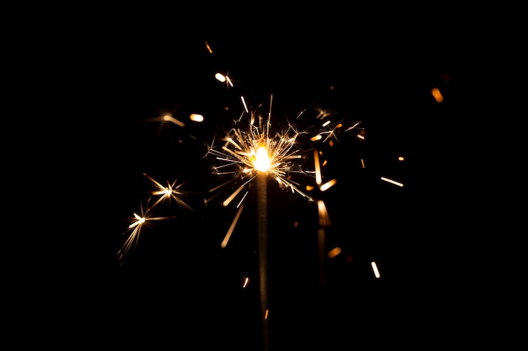 Free Photo festive shiny sparkler in the dark