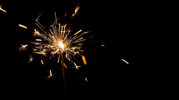 Free photo festive shiny sparkler in the dark