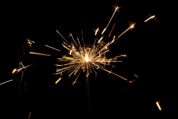 Free photo festive shiny sparkler in the dark