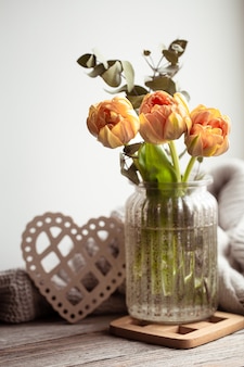 A festive still life with a flower arrangement in a vase and decorative items