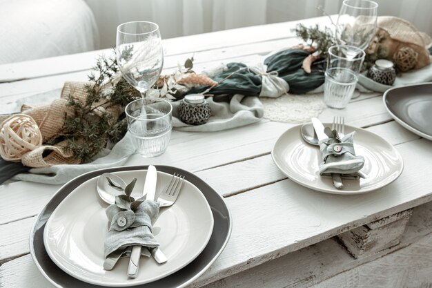 Festive table setting at home with Scandinavian decorative details close up.