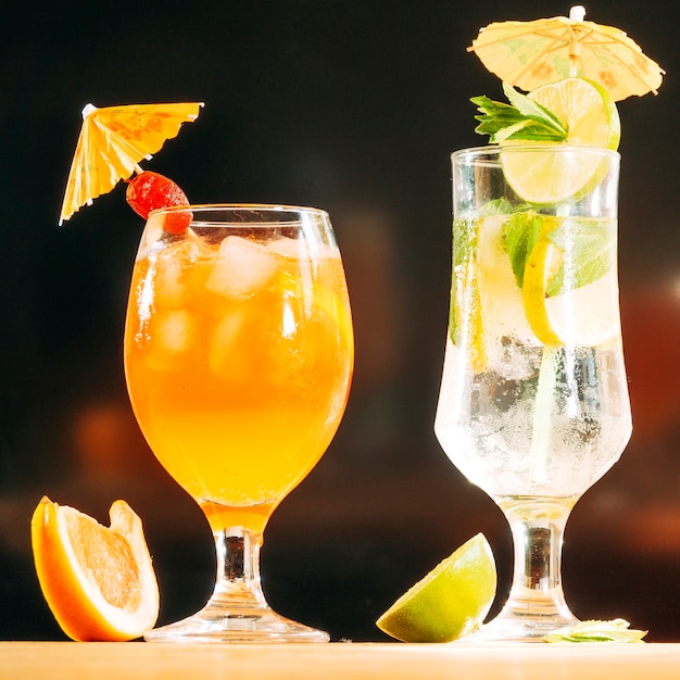 Festively decorated glasses with juicy drink sliced lime and orange