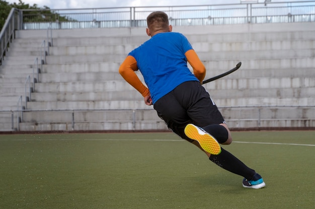 Free photo field hockey player in equipment on the grass