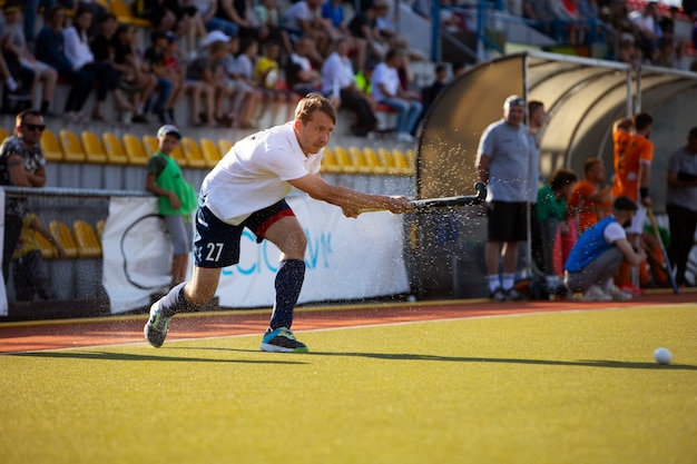 Field hockey player in equipment on the grass