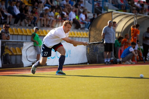 Field hockey player in equipment on the grass