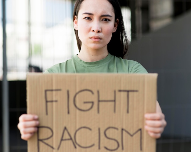 Fight racism quote on cardboard front view