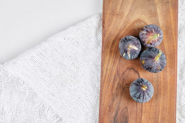 Figs on wooden board and on white.