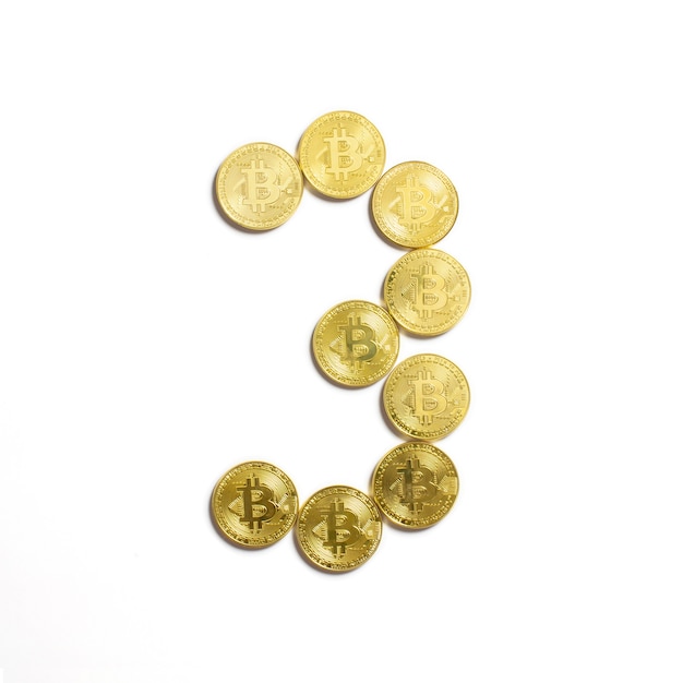The figure of 3 laid out of bitcoin coins and isolated on white background