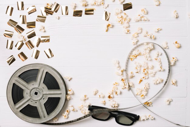 Film bobbin with glasses and popcorn