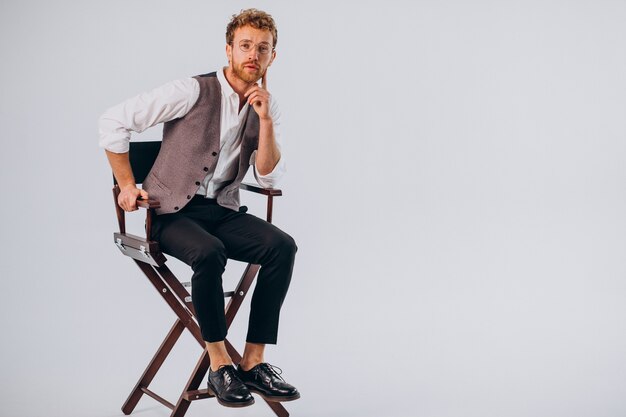 Film director sitting in chair and looking into camera