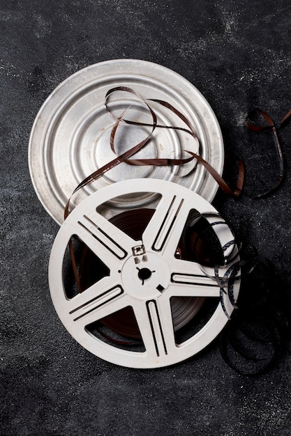 Film reel canister with negative stripes on dark background