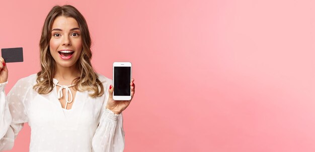 Finance shopping and technology concept closeup portrait of excited blond attractive girl in white d